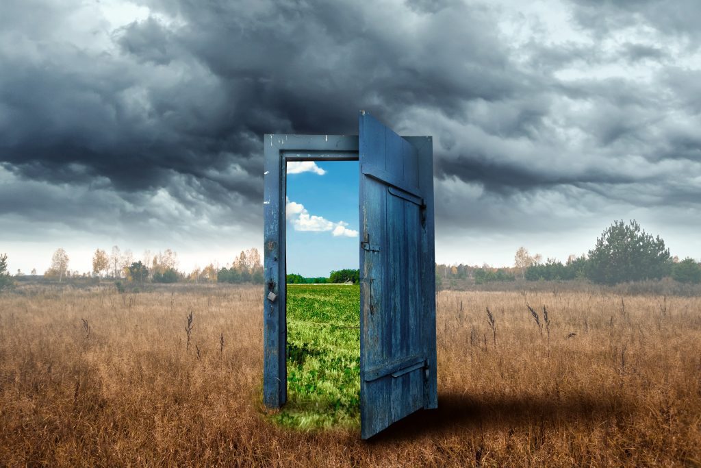 Why we Fail at Change - image of open door inviting us to step from a grey world into one of colour