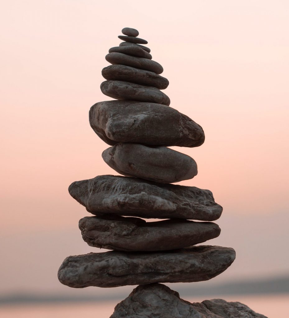 Survivor Syndrome: Gather Information and Act. Pile of stones going from large to small at the top.