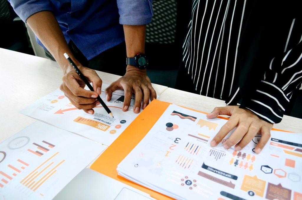 planning for the future in crisis - image of documents on a table with people discussing them